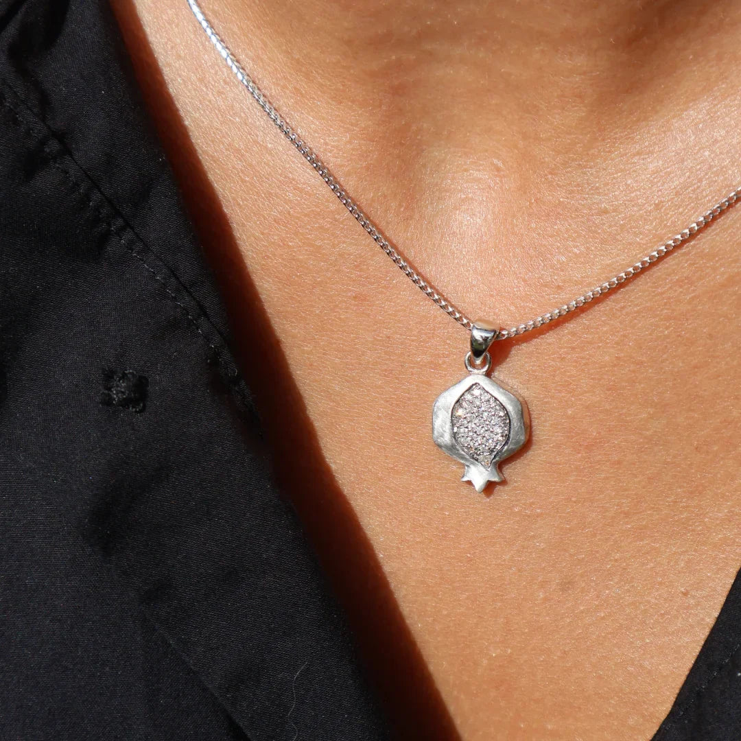 Pomegranate pendant worn with a black top