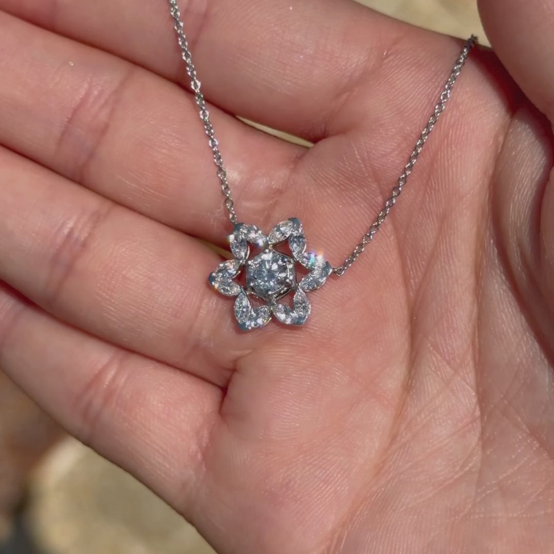 14K White gold Star of David Legacy Necklace with marquise diamonds shown in a hand outdoors